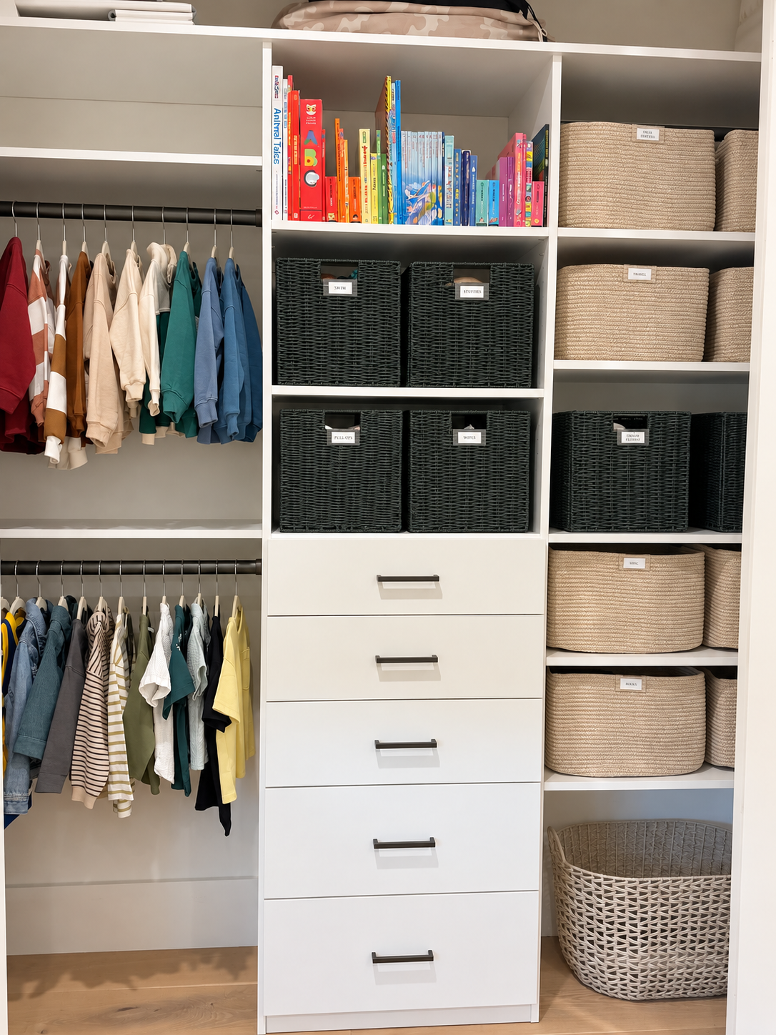 Full organized kids’ closet with color-sorted clothes, books, labeled baskets, and drawers