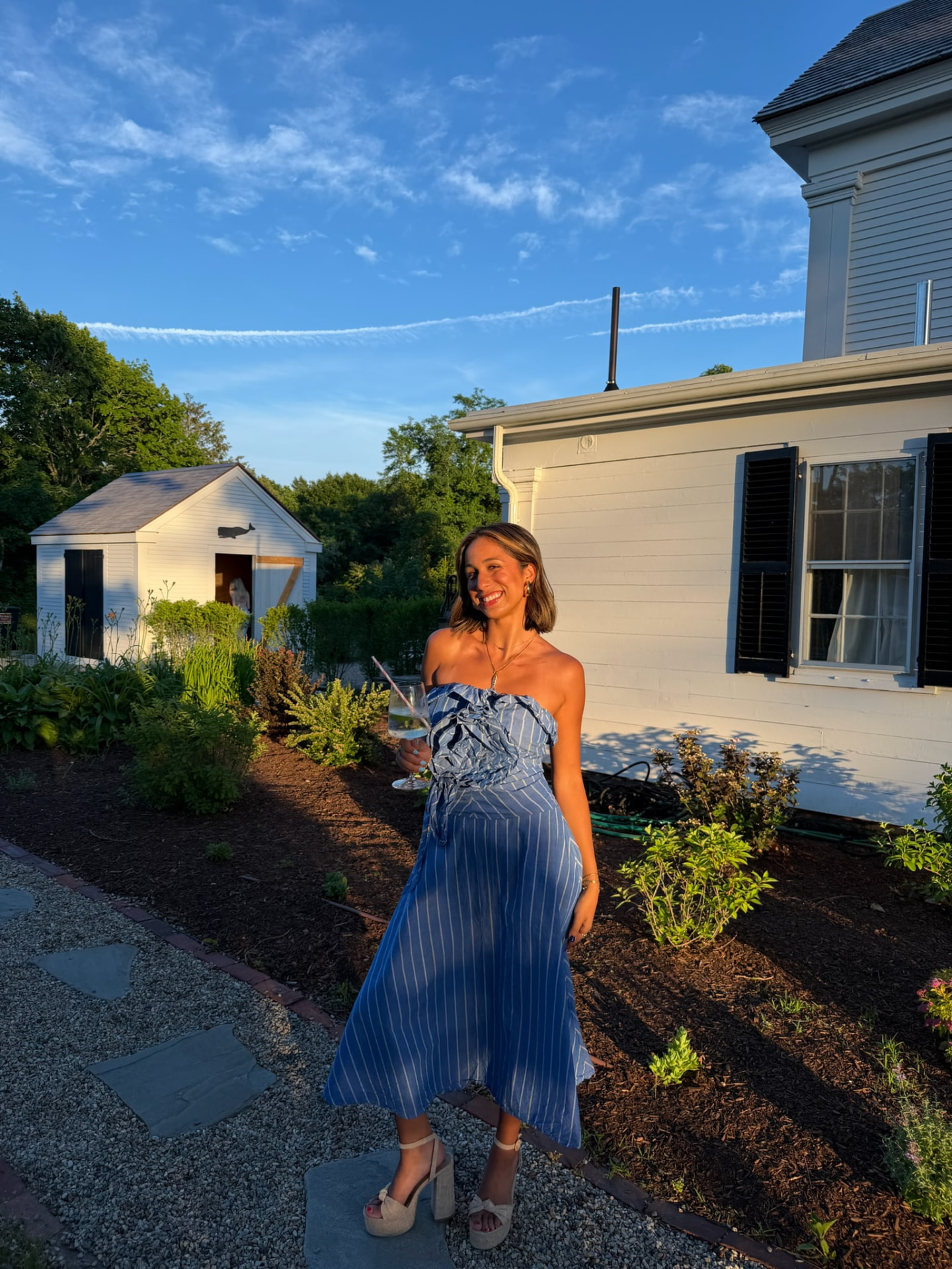 Sonia, founder of Simply Sonia, smiling in a blue dress outdoors